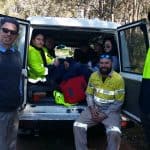 green army members sitting in the back of a van