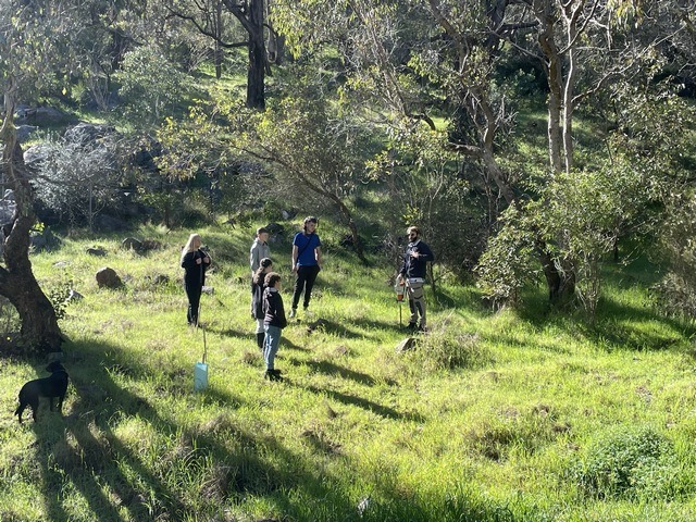 several adult conservation students in bushland